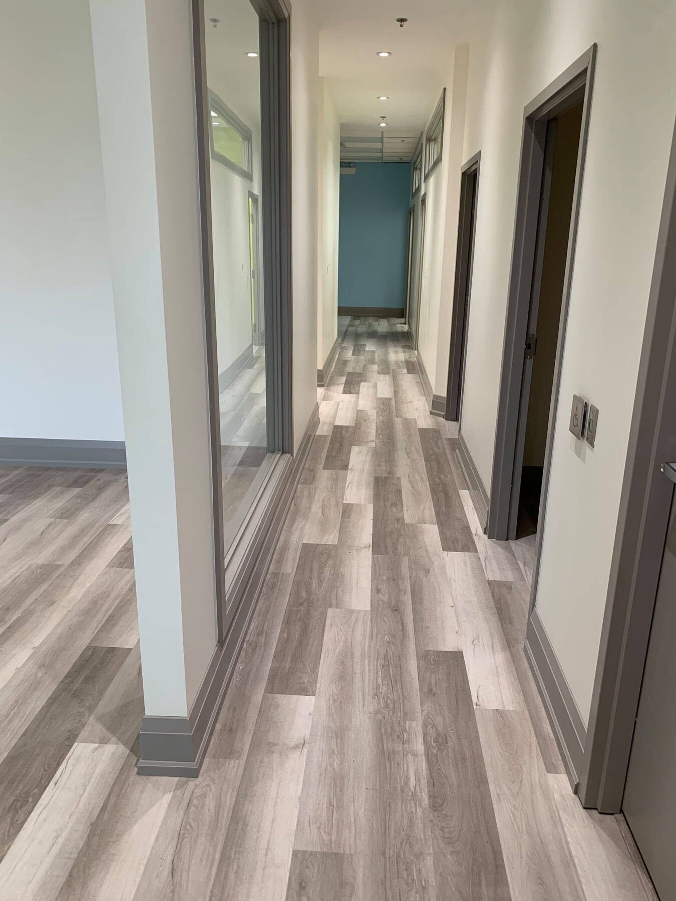 Finished dental clinic corridor and treatment-room circulation