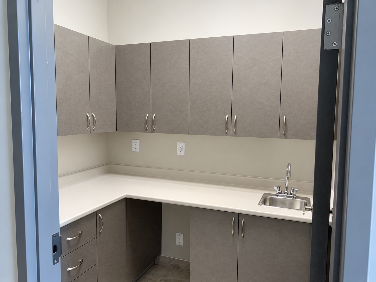 Clinical cabinetry, countertop and sink installed as part of the fit-out.